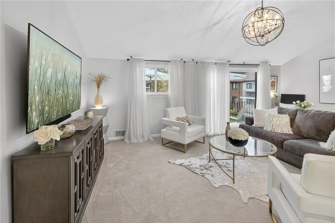 GREAT ROOM W/ VAULTED CEILING AND SLIDER OUT TO THE BALCONY. WALL TO WALL COZY CARPETING.