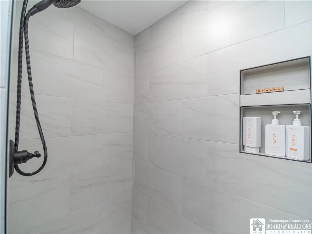 Let your stress melt away in this porcelain spa-like shower.