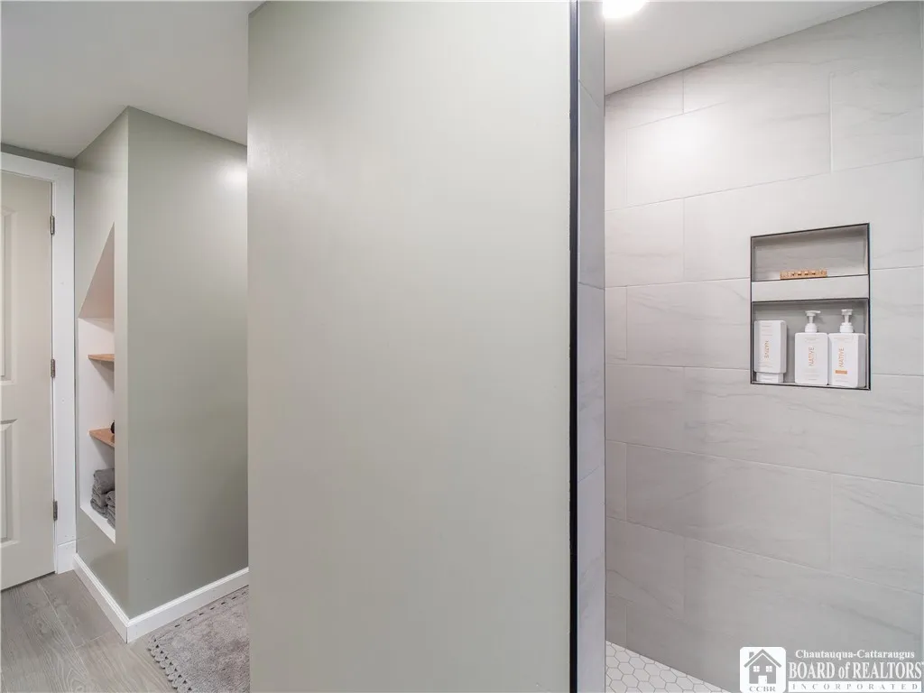 Open air shower with a recessed space leaves no need for a door or curtain.