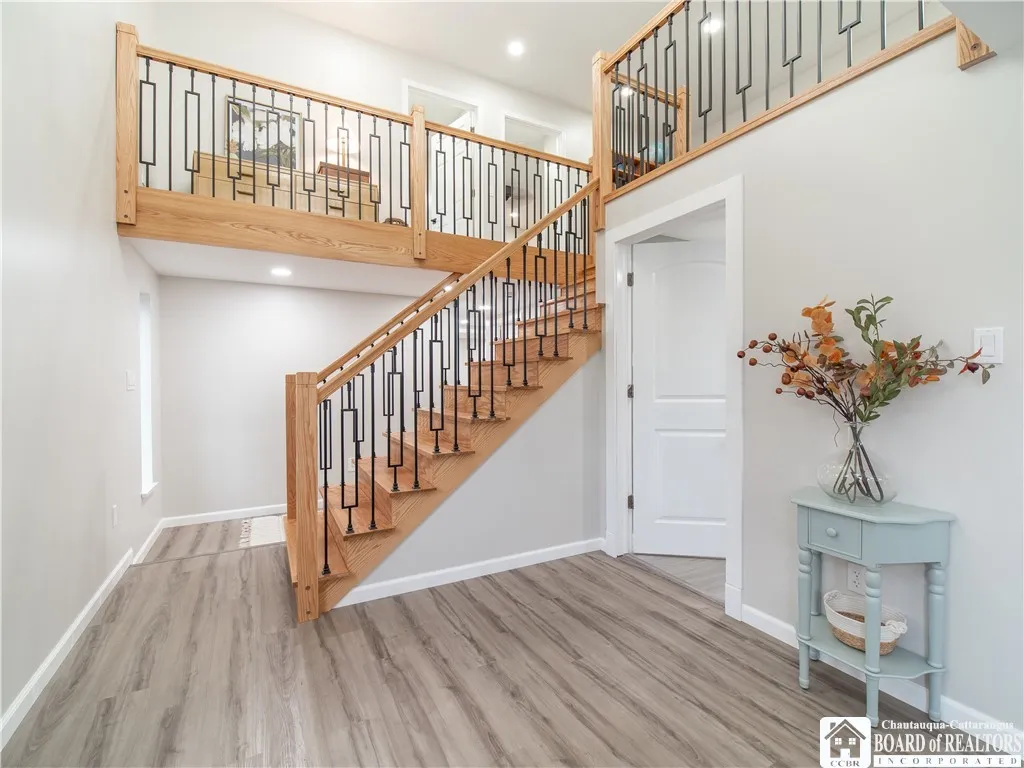 The vaulted entryway features a stunning hand-crafted stairway and banister which is the centerpiece of this lovely home!