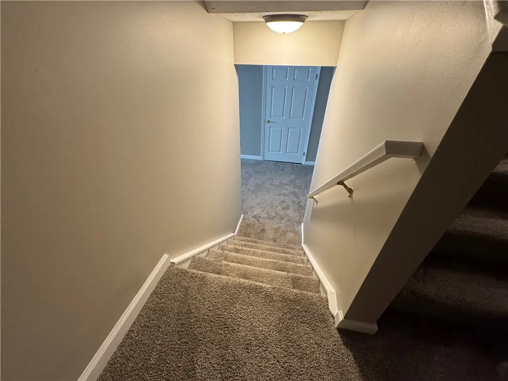 Typical stairway to walk-out full basement (partially finished) & private patio