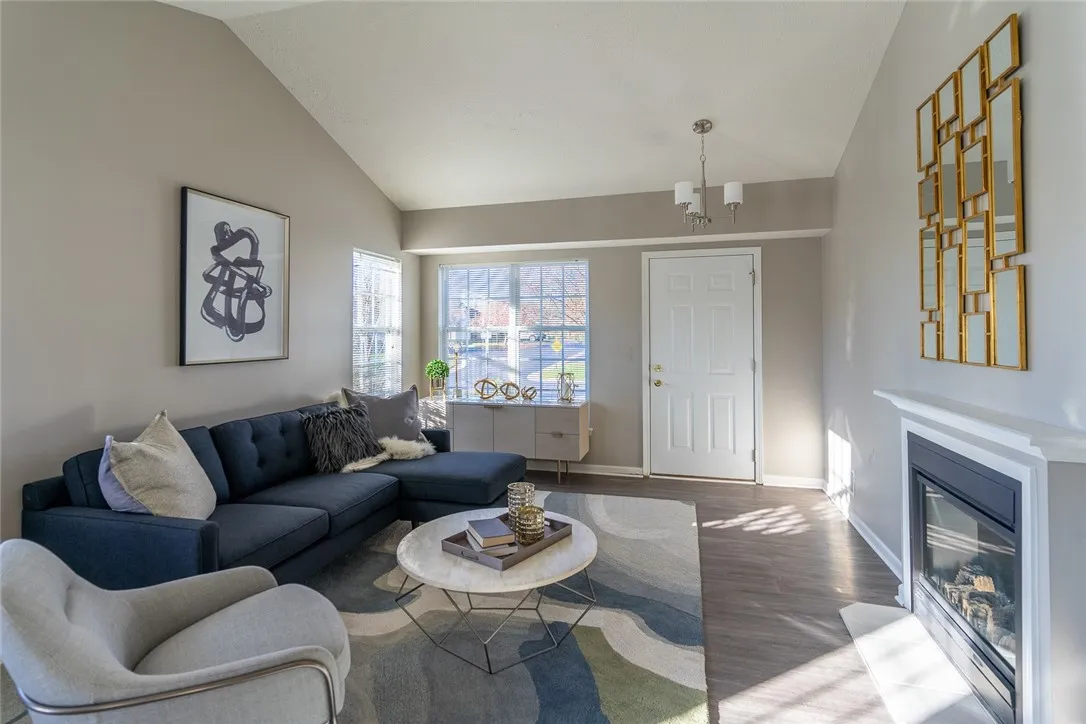 Typical Great Room with fireplace & vaulted ceiling for 2-bedroom 1.5-bath ranch townhome with walkout basement