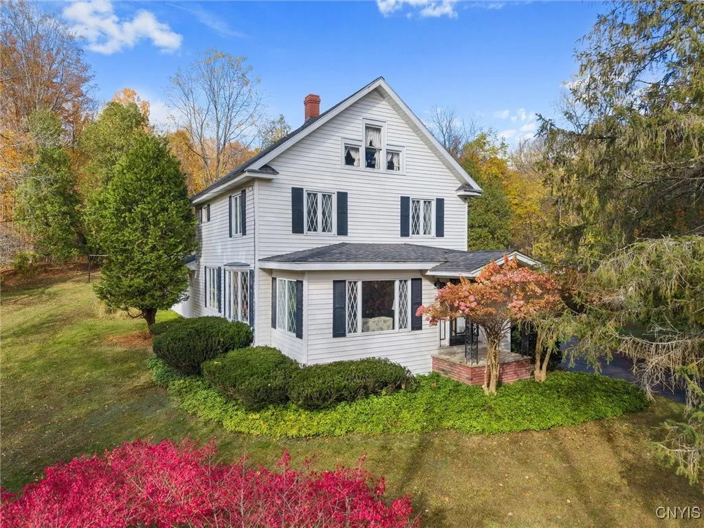HOME IS BEAUTIFULLY FRAMED BY FALL FOLIAGE
