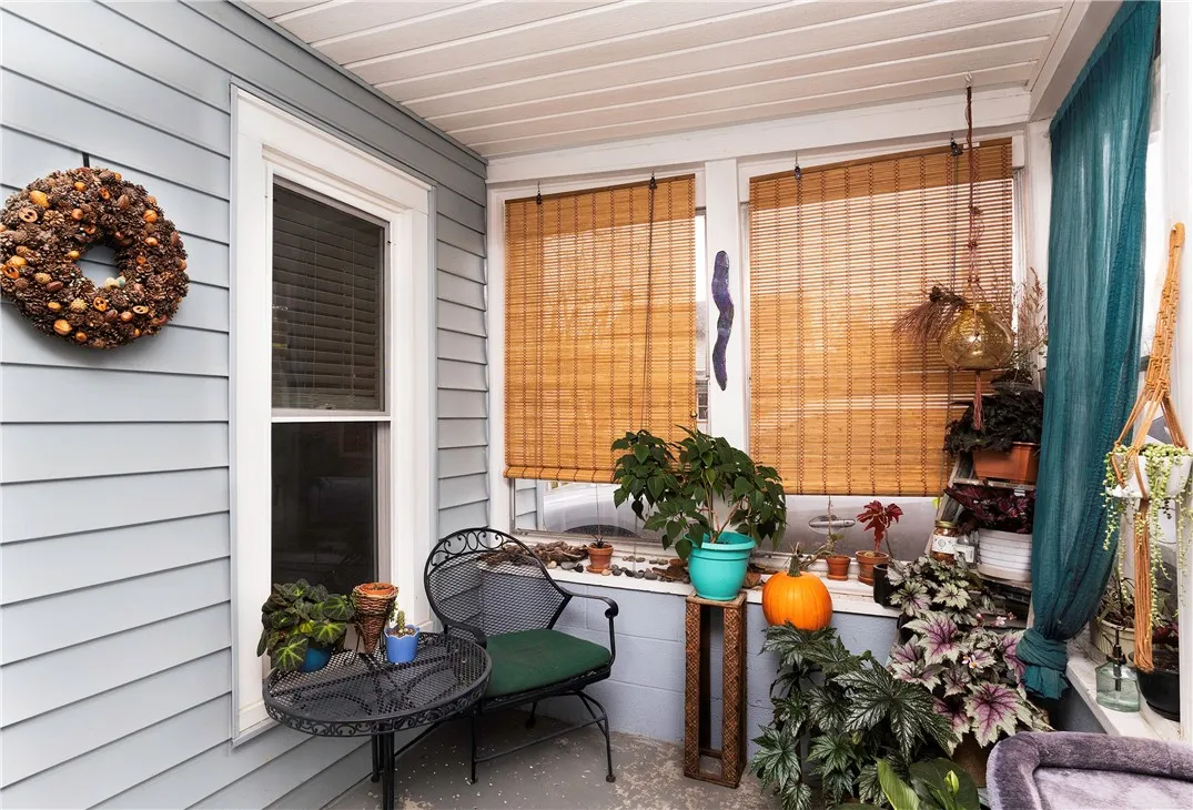 Enclosed Front Porch – 121 Owego Street, Montour Falls. Inviting enclosed porch perfect for relaxing with morning coffee or enjoying an evening breeze. Features cozy seating, natural light, and space for plants or seasonal décor.