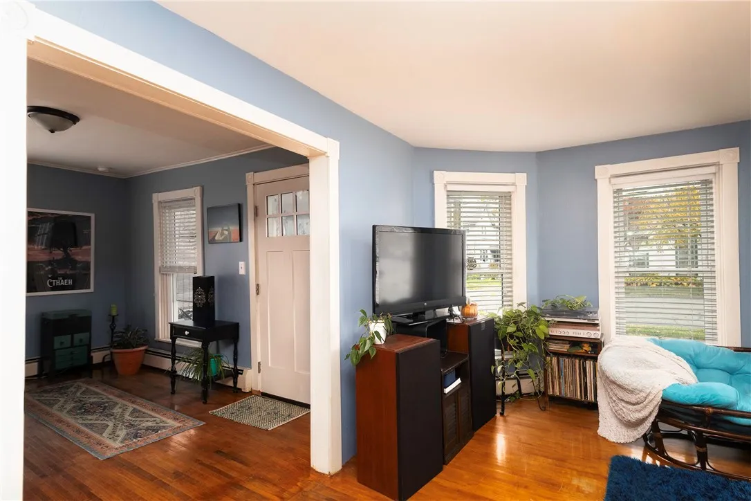 Welcoming front entry with hardwood floors and abundant natural light. Opens to the living area, creating an inviting first impression and an easy flow throughout the main level.