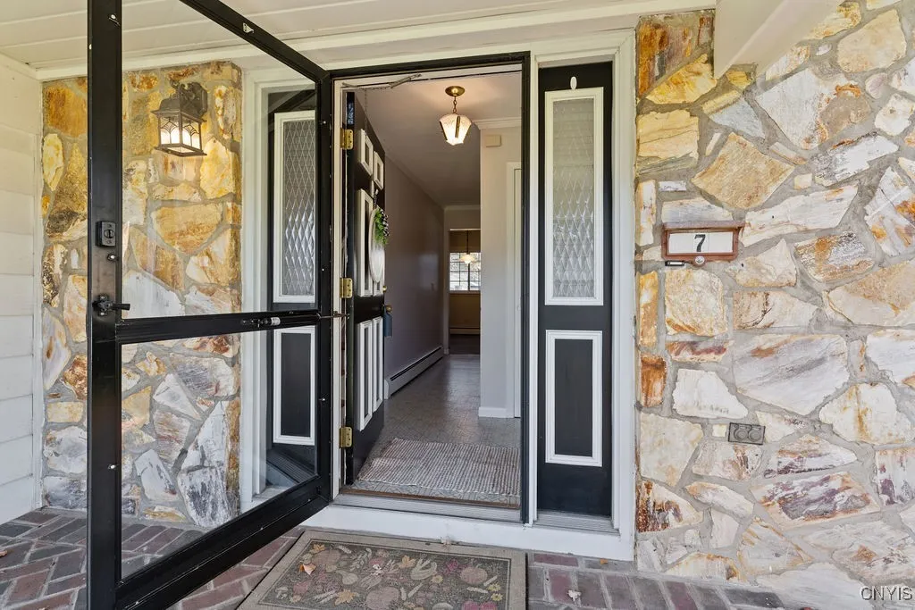 Storm door perfect to let the sun shine through.  Stone front gives so much character to this entrance.