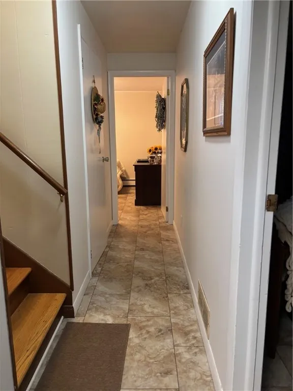 lower level hallway to laundry on left and straight ahead to office