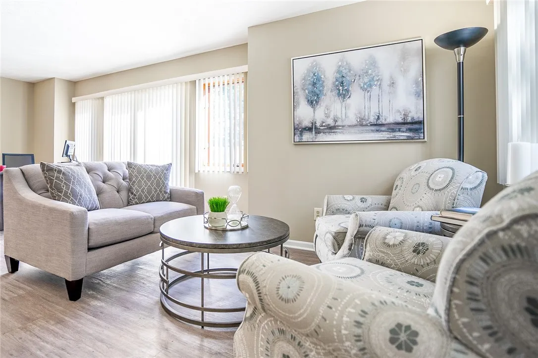 Typical Great Room with plank floors (view shows living area and sliding glass doors to private patio/deck)