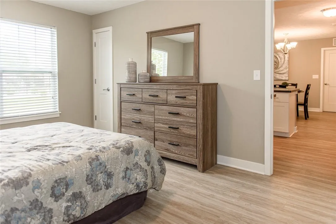 Typical view from primary bedroom towards hall to kitchen and great room