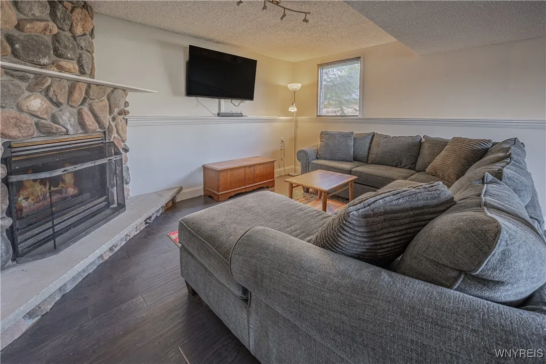Spacious family room with a beautiful stone gas fireplace.