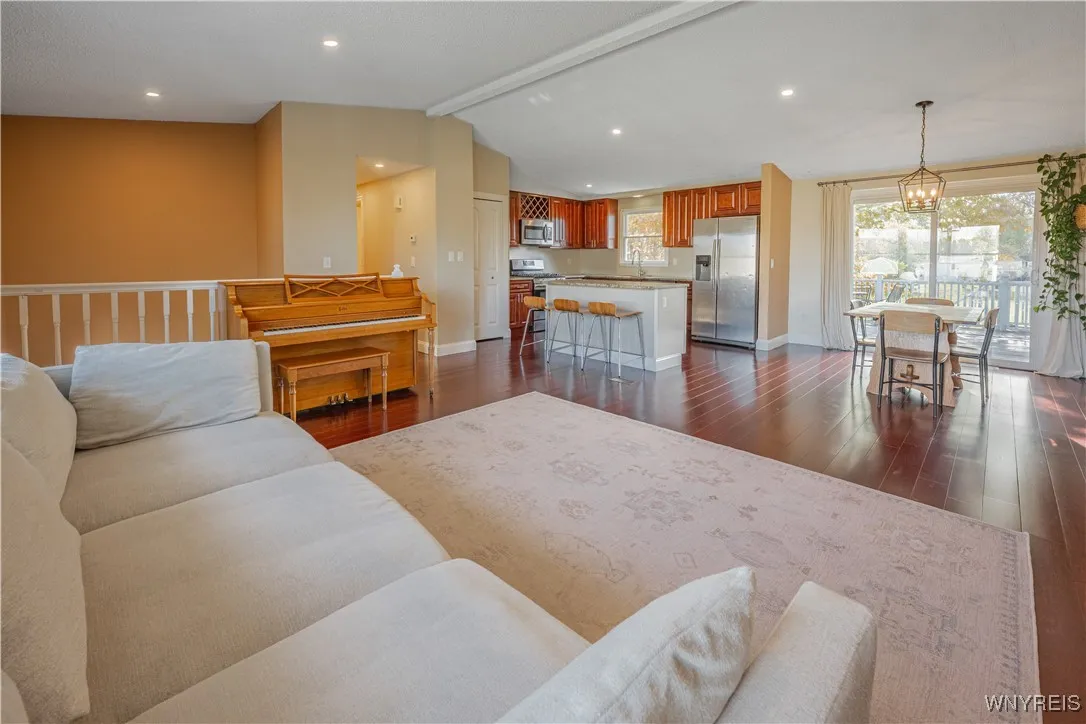 Open-concept living room flows seamlessly into the dining area and kitchen — perfect for modern living and entertaining.