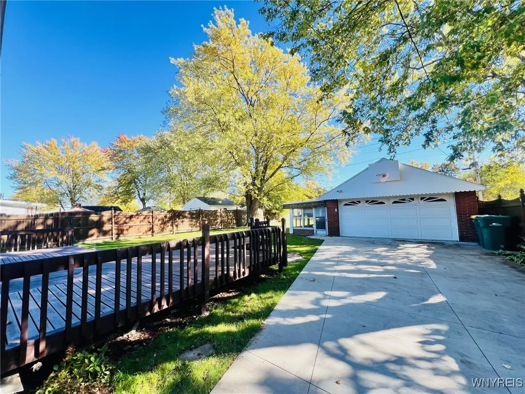 two car garage with attached enclosed patio
