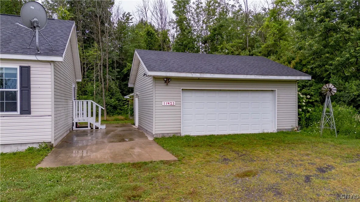 This spacious two-car garage comes fully equipped with power—ideal for winter months, EXTRA ROOM FOR PLEANTY OF STORAGE, OR AWORK BENCH.