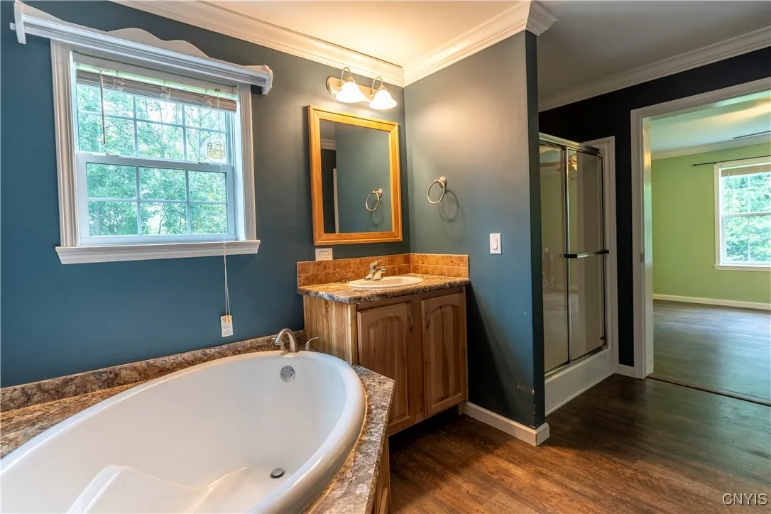 The primary suite is a true retreat, offering a stylish bathroom and a roomy walk-in closet designed to meet all your storage needs.