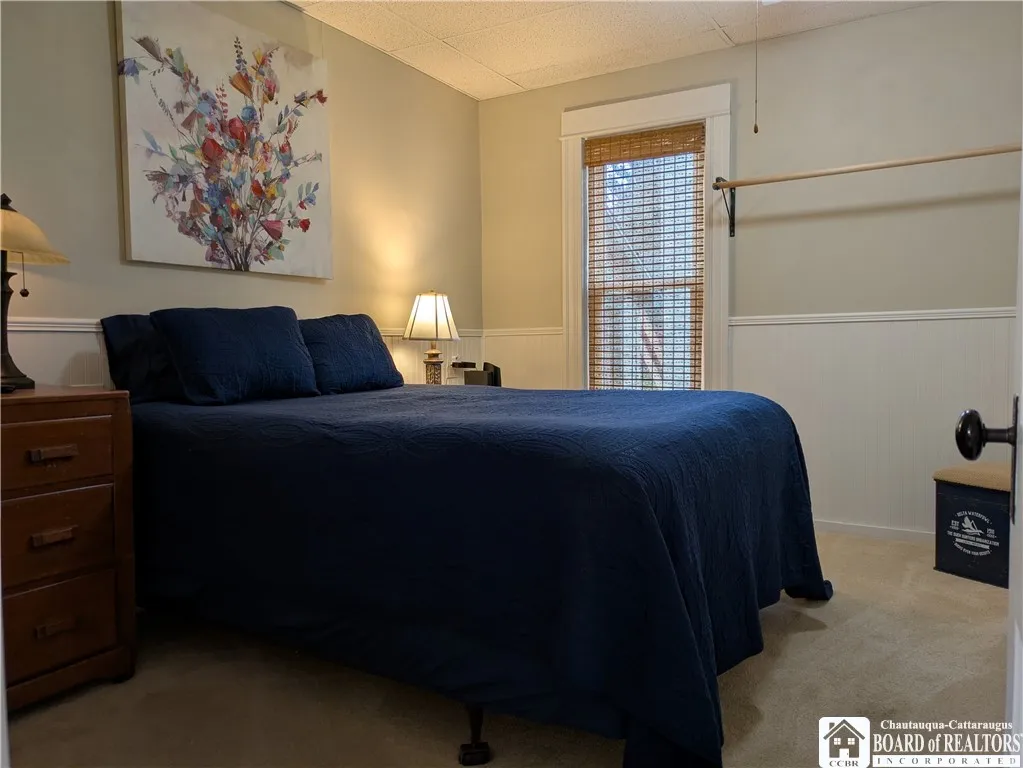 First floor bedroom with bead board on the walls