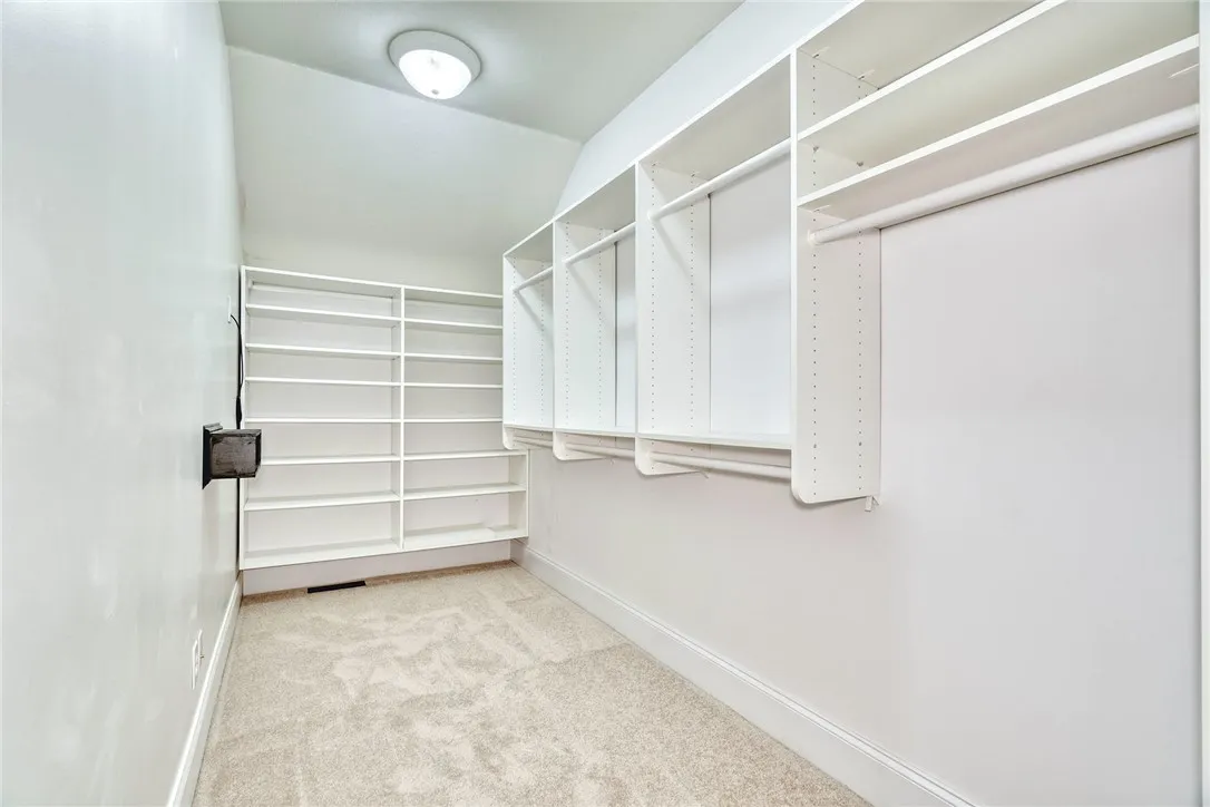 Large walk-in closet with built-ins keeps it calm and organized.