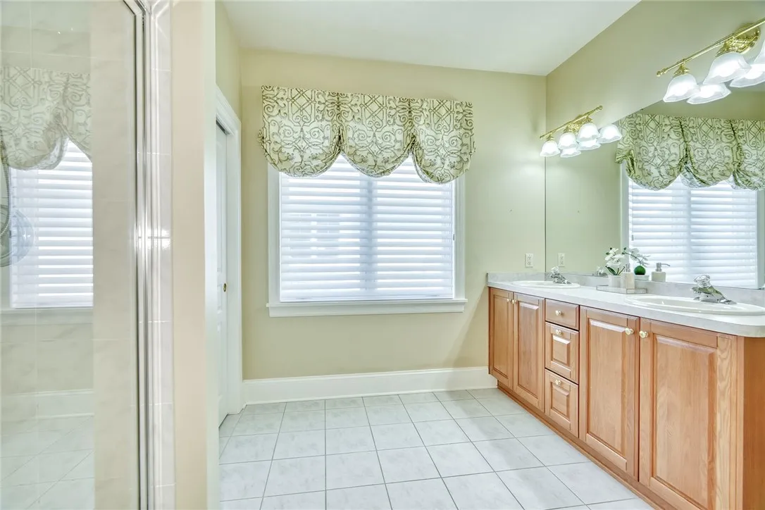 Primary Ensuite with Double sink vanity and step in tiled shower.