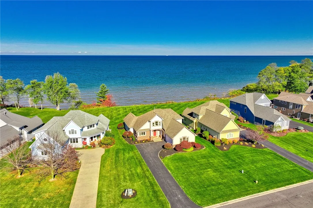 Enjoy elevated sweeping views of the Lake and a large level lot.