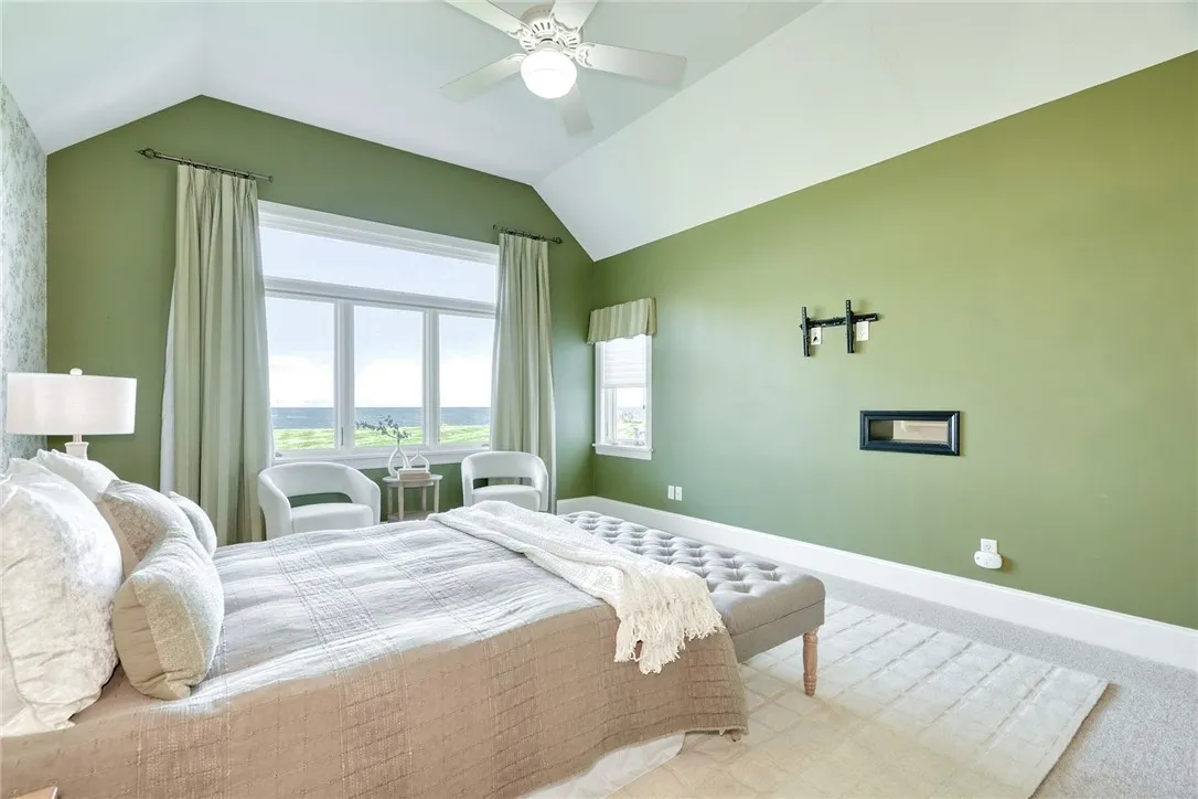 Wake up to the water! Volume ceilings, generous windows, and a true exhale—the primary suite lives on the first floor, so mornings start with the lake.