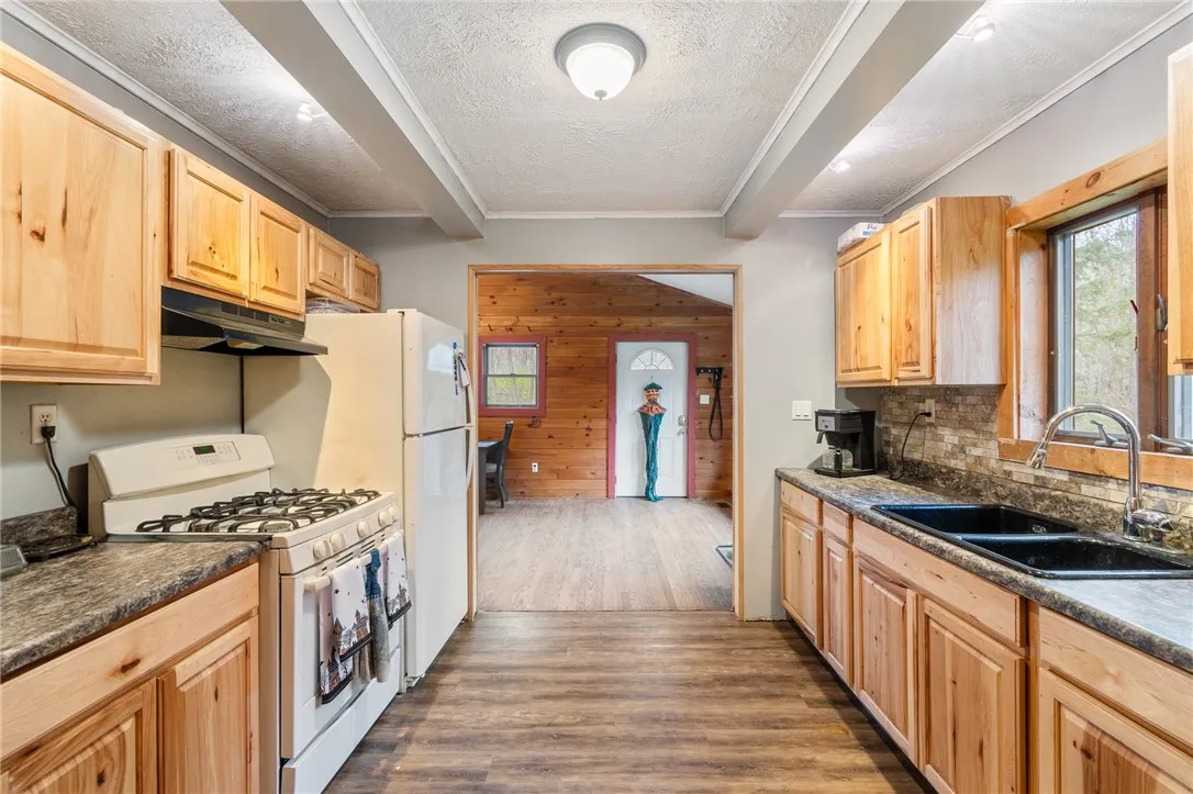 The kitchen view shows the DOOR TO THE DECK- imagine enjoying your meals out there enjoying the views of your own land!