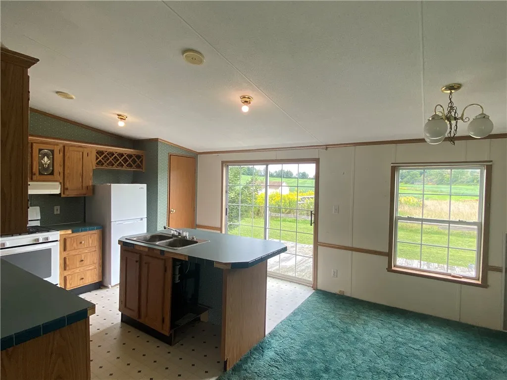 Great views of backyard with slider to deck.