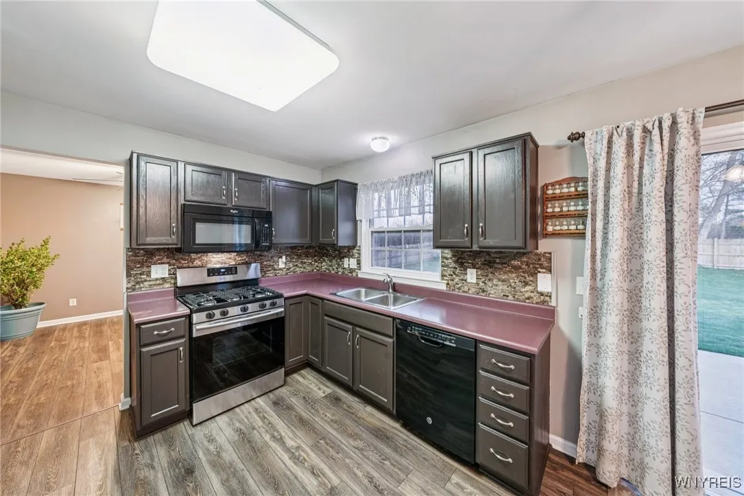 Kitchen leading into the dining room and sliding glass doors out to patio and private yard. Perfect for entertaining.