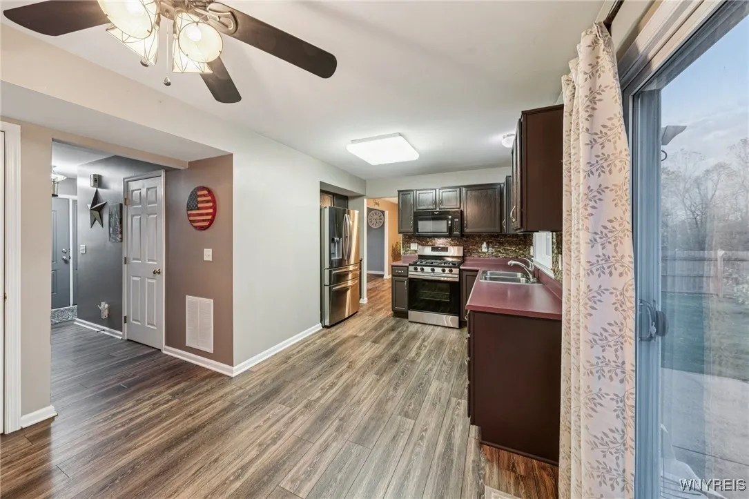 half bath tucked in between  eat-in kitchen and entrance