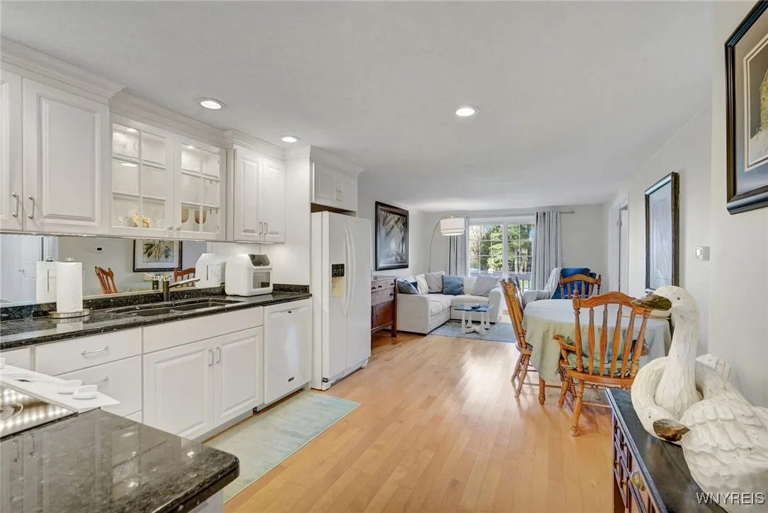 Open kitchen and living room with new cabinetry and new hardwood floors