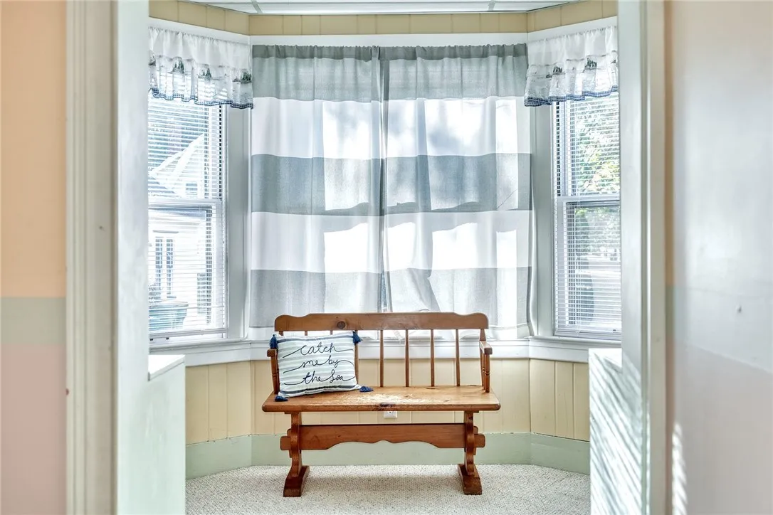 two adjoining rooms — a bright office and a window-wrapped sunroom currently used as a playroom.