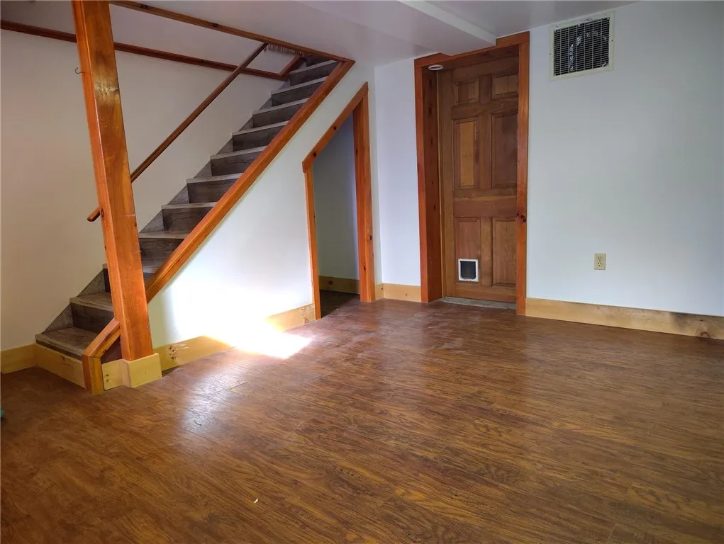 Finished basement room with under stair storage.