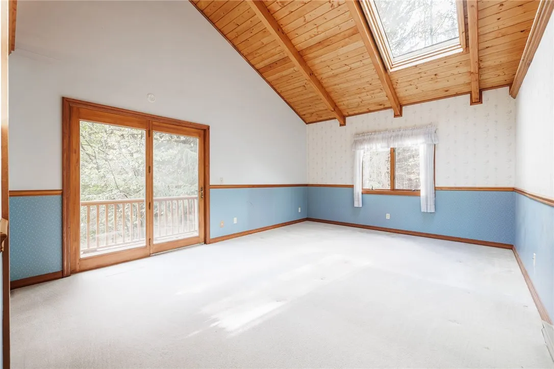 Bright primary bedroom/loft with skylight