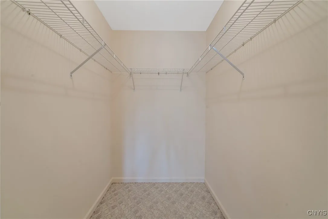 Primary bedroom walk in closet