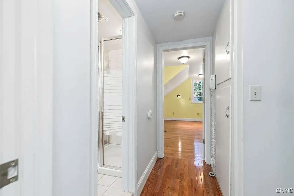 A bright, clean hallway connects the two second-floor bedrooms, featuring ample closet storage for added convenience and organization.