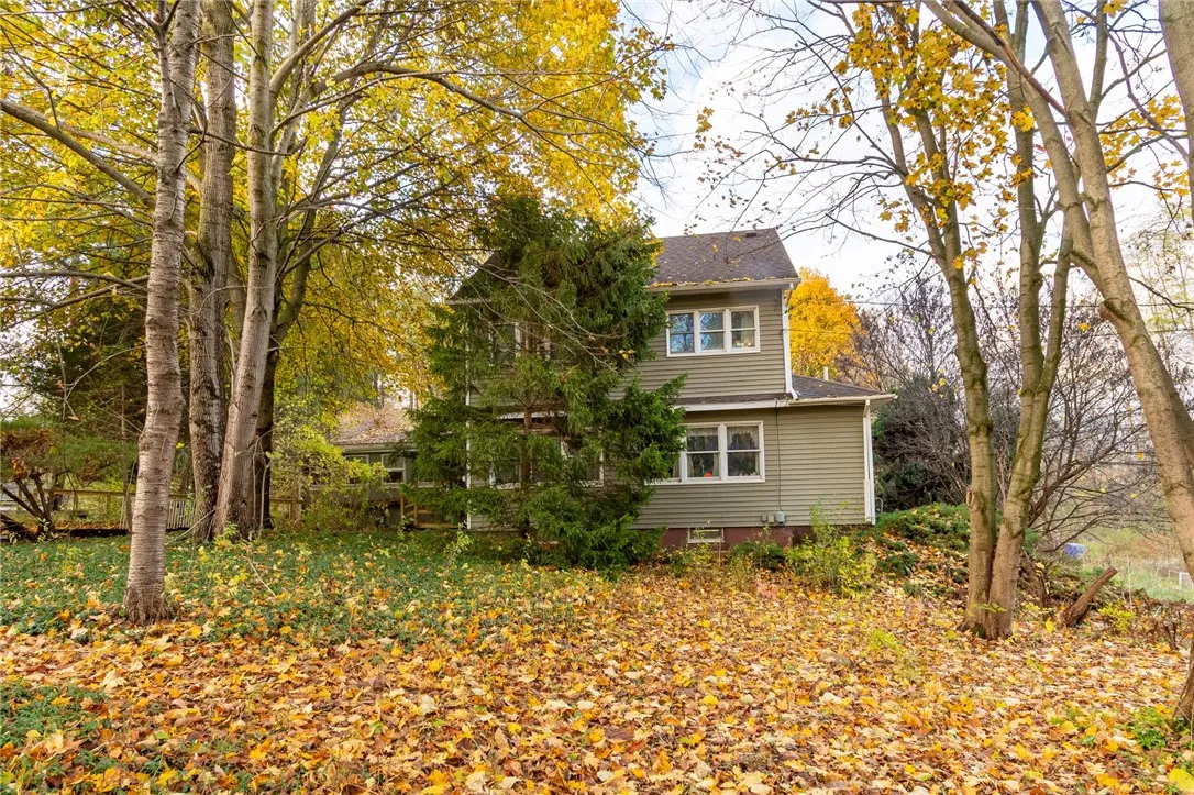 The side view of the home - the slight slope on one side helps keep the basement dry! There’s even a patio off the rear enclosure.