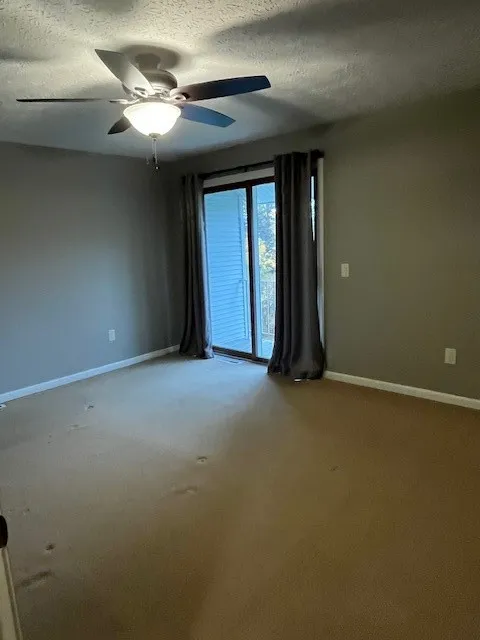 Primary Bedroom view of sliders to the balcony!