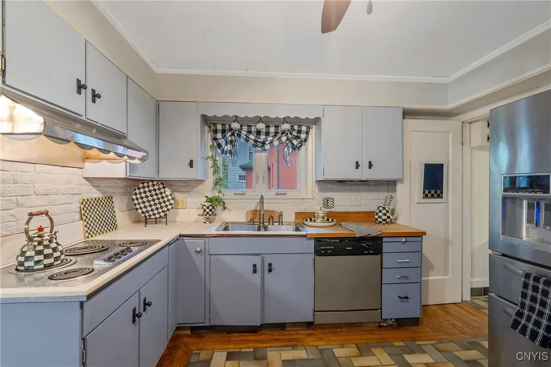 And before we head upstairs, let's not miss the doorway to the right which connects us to the basement, an auxiliary exit to the side yard, as well as a well-placed powder room.