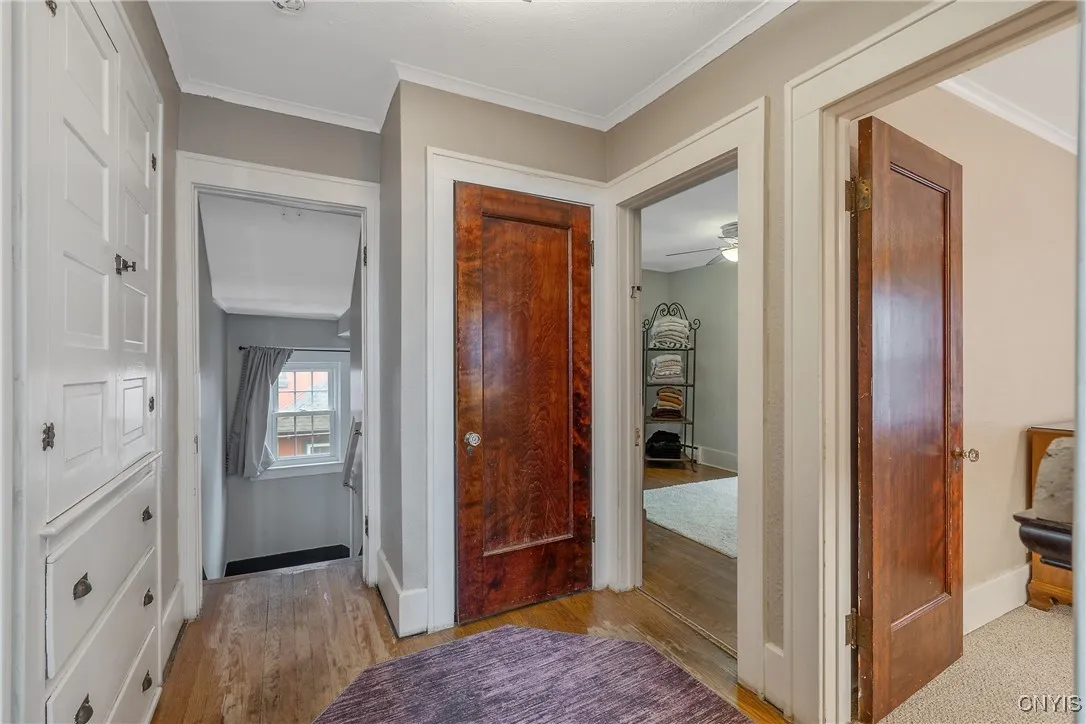 Now we ascend the stairs to explore the bedroom level. The amazing built-in cabinet and drawers make for a great linen closet to stockpile your toiletries, linens and towels. The door straight ahead continues up to the attic. There is just no lack of storage throughout this place!