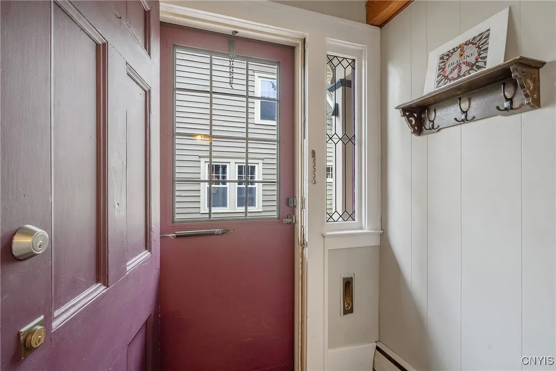 Just inside the front door is a smartly placed vestibule offering a place to shed outdoor layers, and keep the mess of inclement weather out of the main living area. The decorative sidelight windows and adorable mail slot keep the turn-of-the-century flair.