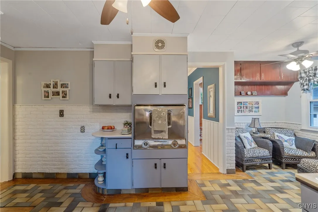 Additional storage and counter space is shown here beside the built-in oven. What a great spot for a coffee bar or wine rack. Shelves below are also a nice place for your attractive kitchen appliances.