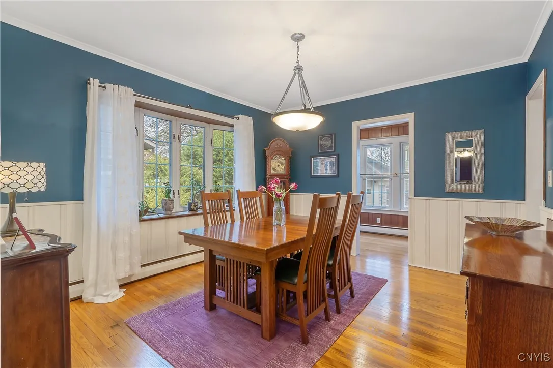 Crisp white wainscoting contrasts the fresh coat of paint in the walls here. If we head right, we start into the kitchen, but first go straight into the office/den tucked at the back of the house.