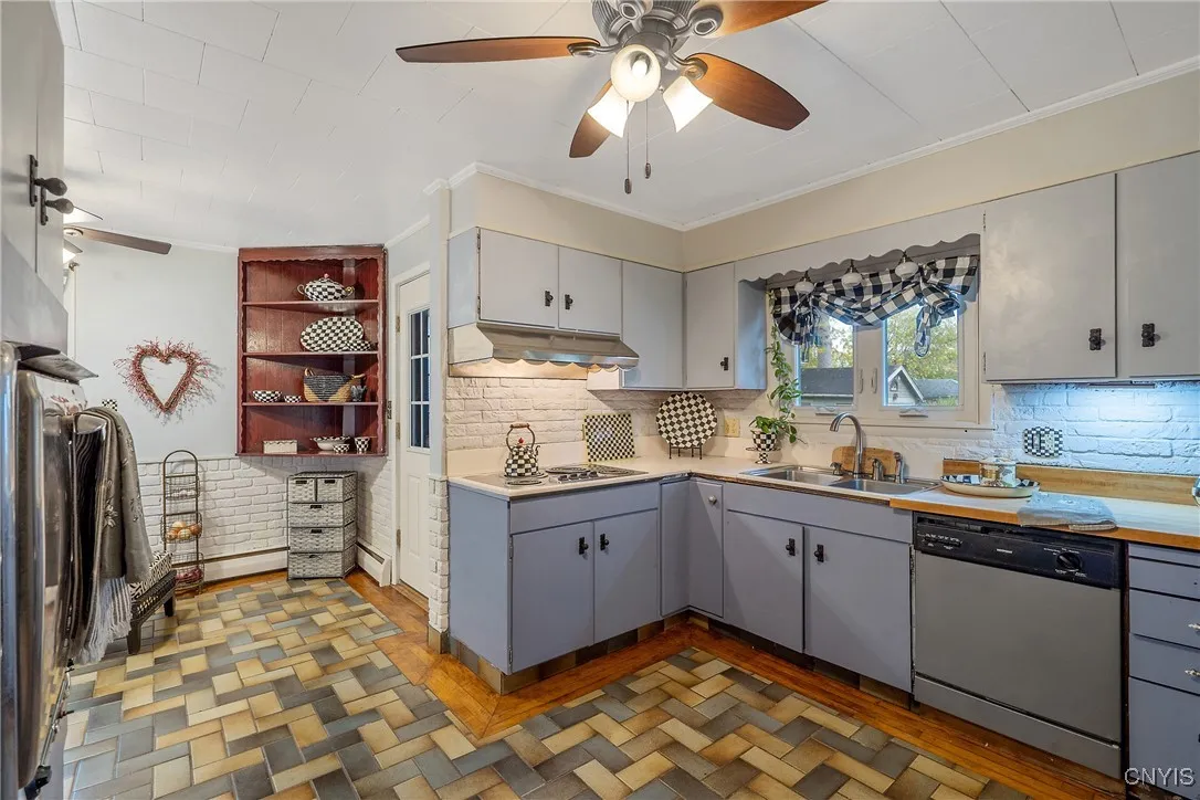 No lack of elbow room in the roomy kitchen. Ahead is the pedestrian door stepping out to the back porch right next to the eat-in breakfast nook.