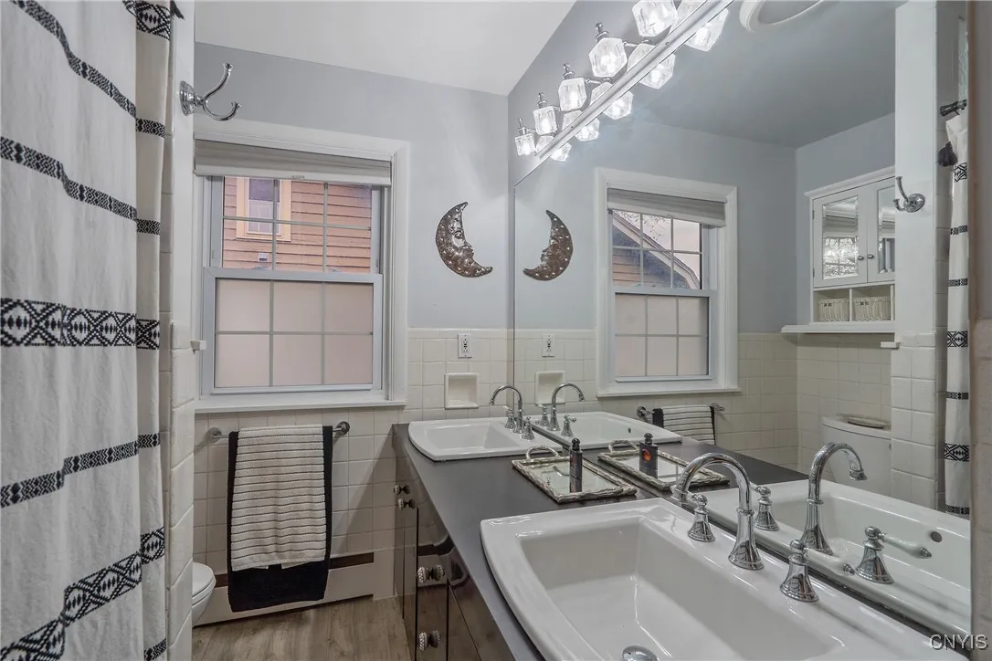 Prepare to be in awe with the updates to the full bathroom. The long vanity counter and double sink offer lots of space for your daily ablutions, while enjoying the designer lighting fixture, sinks and faucets.