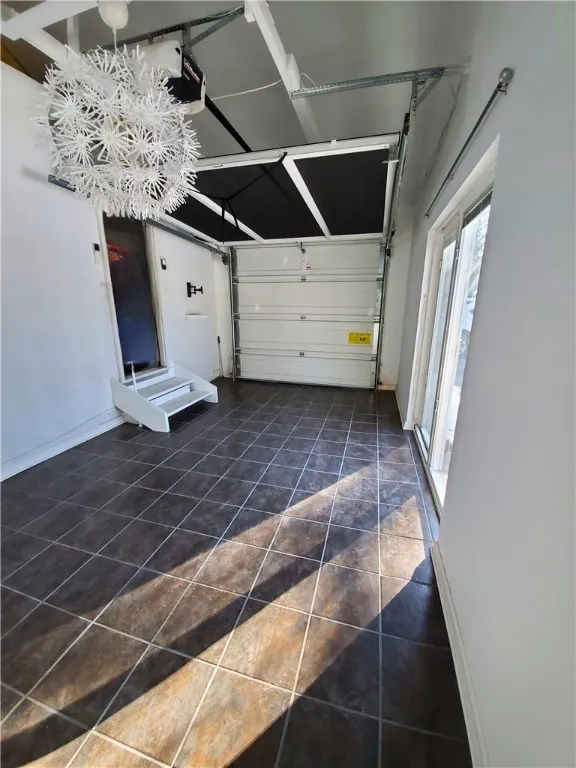 Interior view of 1 car garage, features a heating and cooling system.