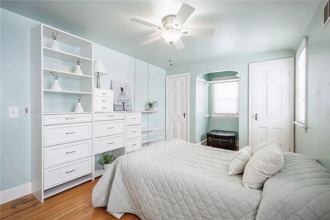 Spare bedroom features built in cabinetry.