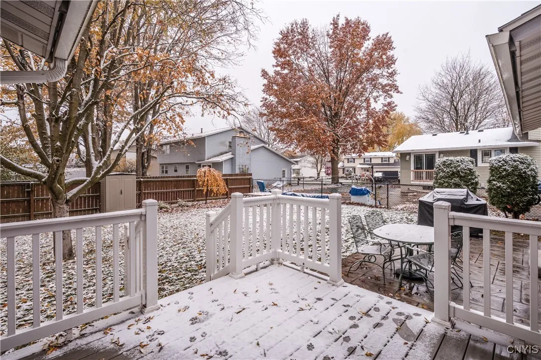 New composite deck leads to new stampcrete patio within the fenced rear yard.