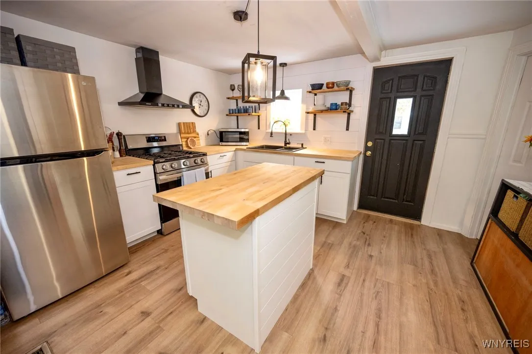 renovated kitchen w stainless steel appliances and island