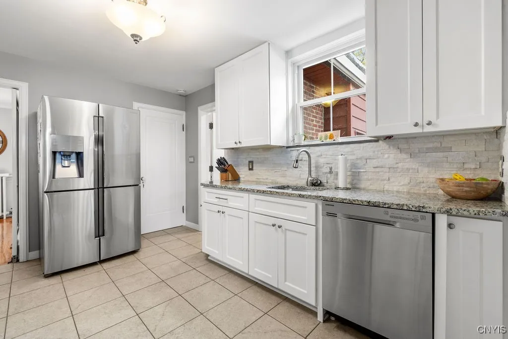 The window above the sink looks out into the backyard.