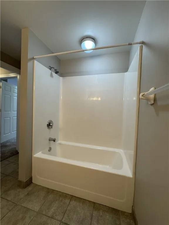 View of typical full bathroom shower/tub combo