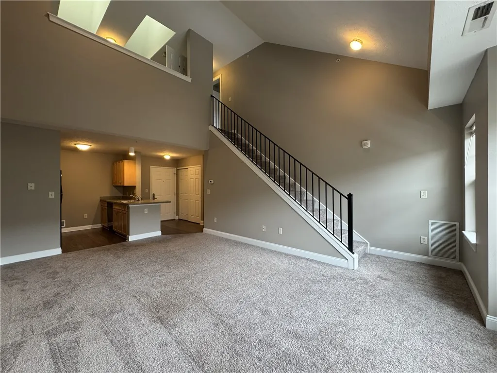 Typical view from great room towards stairs to second floor bedroom and loft area (NOTE: Some great rooms have carpet, and some are plank)