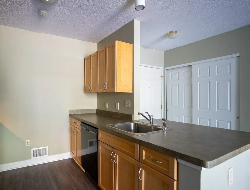 Typical kitchen in a 1-bedroom, 1.5-bath apartment with breakfast bar